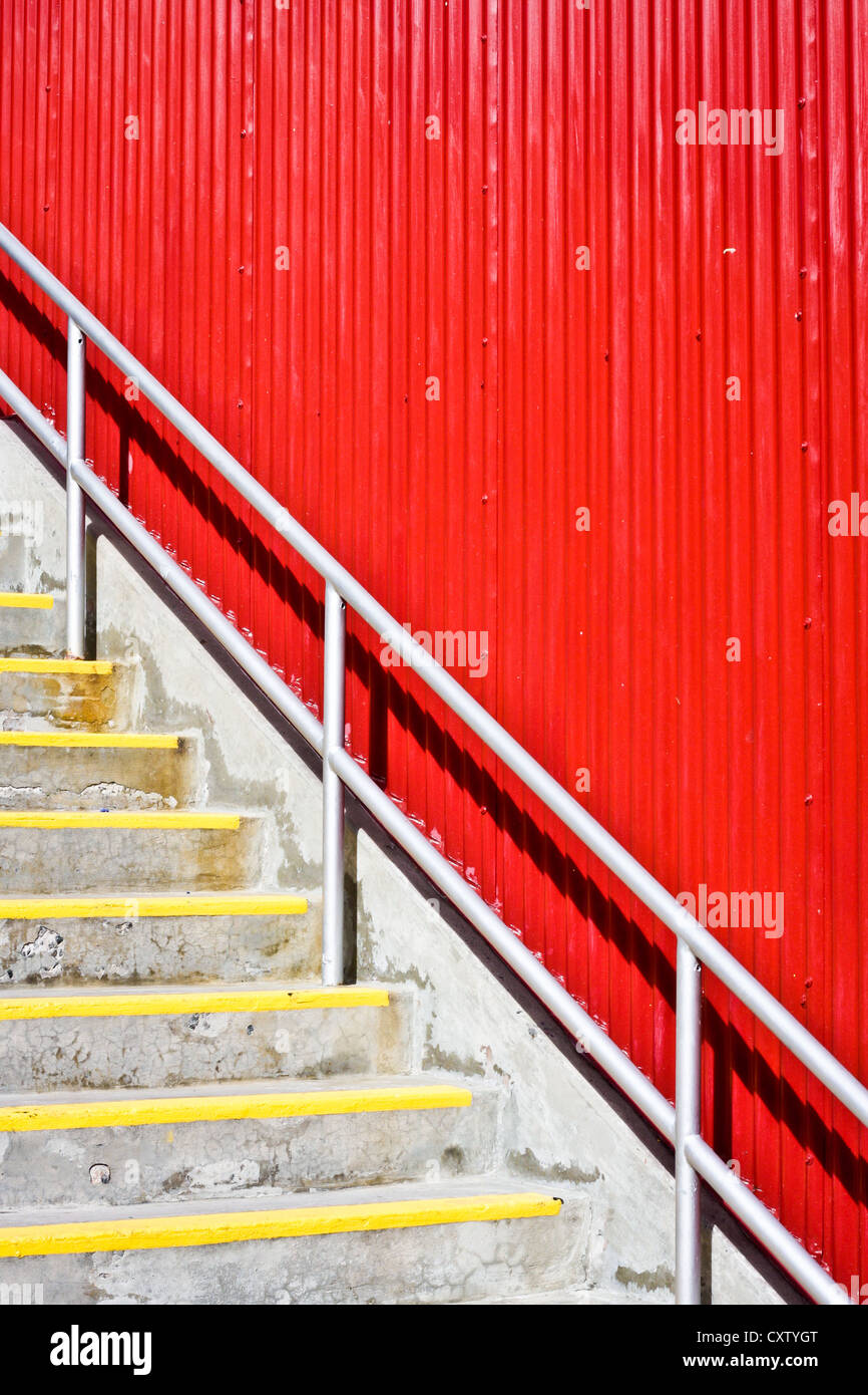Concrete staircase in front of a bright red wall Stock Photo