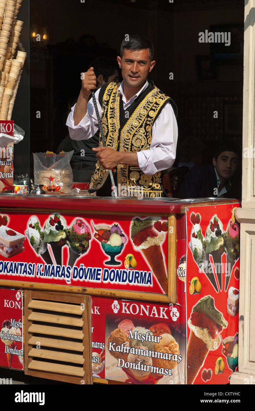Ice cream vendor in a traditional Turkish dress at an ice cream parlor, Istanbul,Turkey Stock Photo
