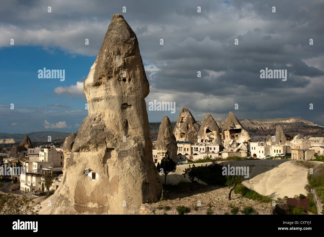 tuff rock cones or fairy chimneys with cut-out living space or storage facilities, Goreme, Cappadocia, Turkey Stock Photo