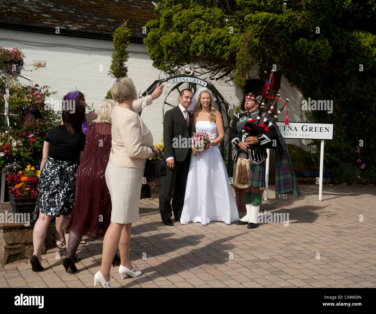 Newlyweds pose for photos to be taken at Gretna Green following the Marriage ceremony.  SCO 8655 Stock Photo