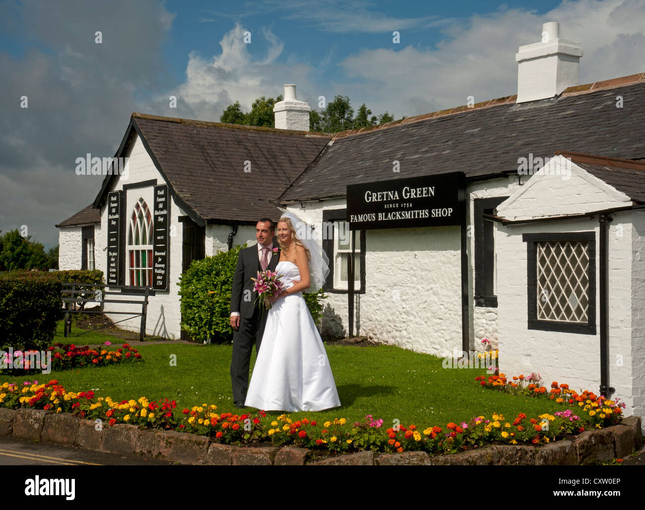 Newlyweds pose for photos to be taken at Gretna Green following the Marriage ceremony.  SCO 8657 Stock Photo