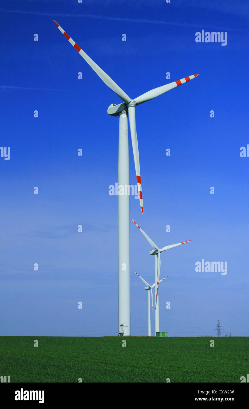 Wind turbines over blue sky Stock Photo - Alamy