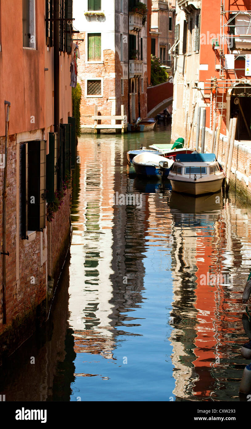 Venice, colorful view of a canal with houses reflection in the water ...