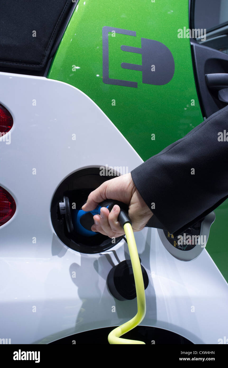 Electric SMART car being recharged at Paris Motor Show 2012 Stock Photo
