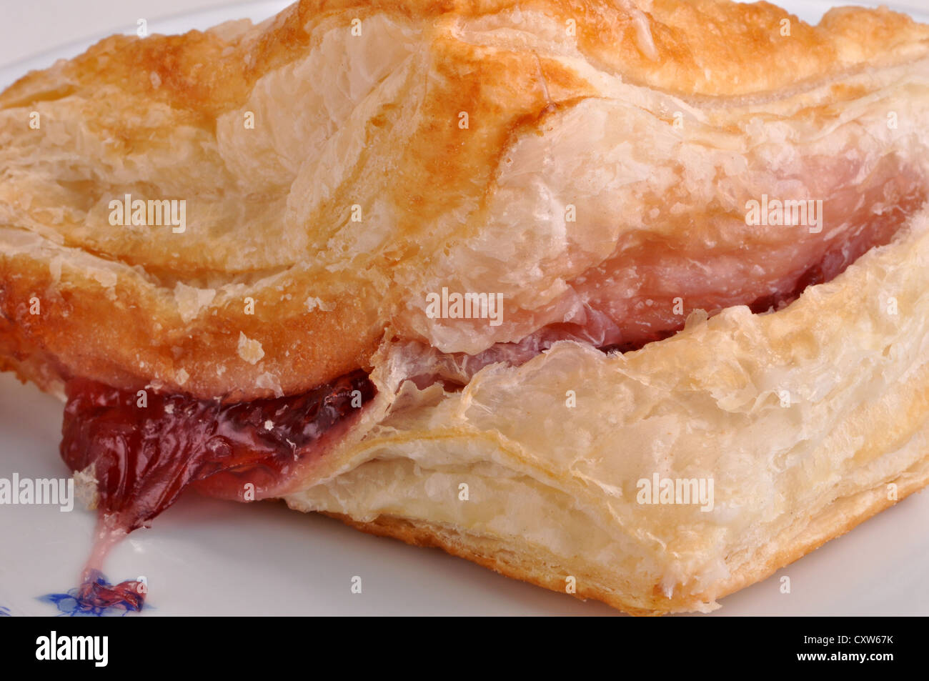 A closeup view of a cherry turnover on a saucer Stock Photo