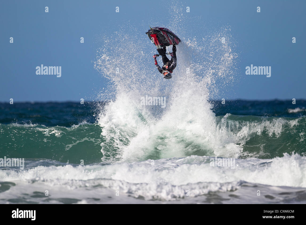 Freeriding Jetski doing an inverted jump off a wave at Fistral Beach in Newquay, Cornwall, UK Stock Photo