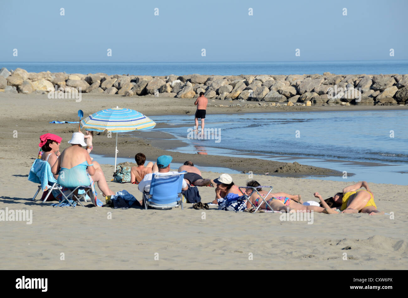 Beach and Holiday Makers or Tourists at Les Saintes-Maries-de-la-Mer Camargue Provence France Stock Photo