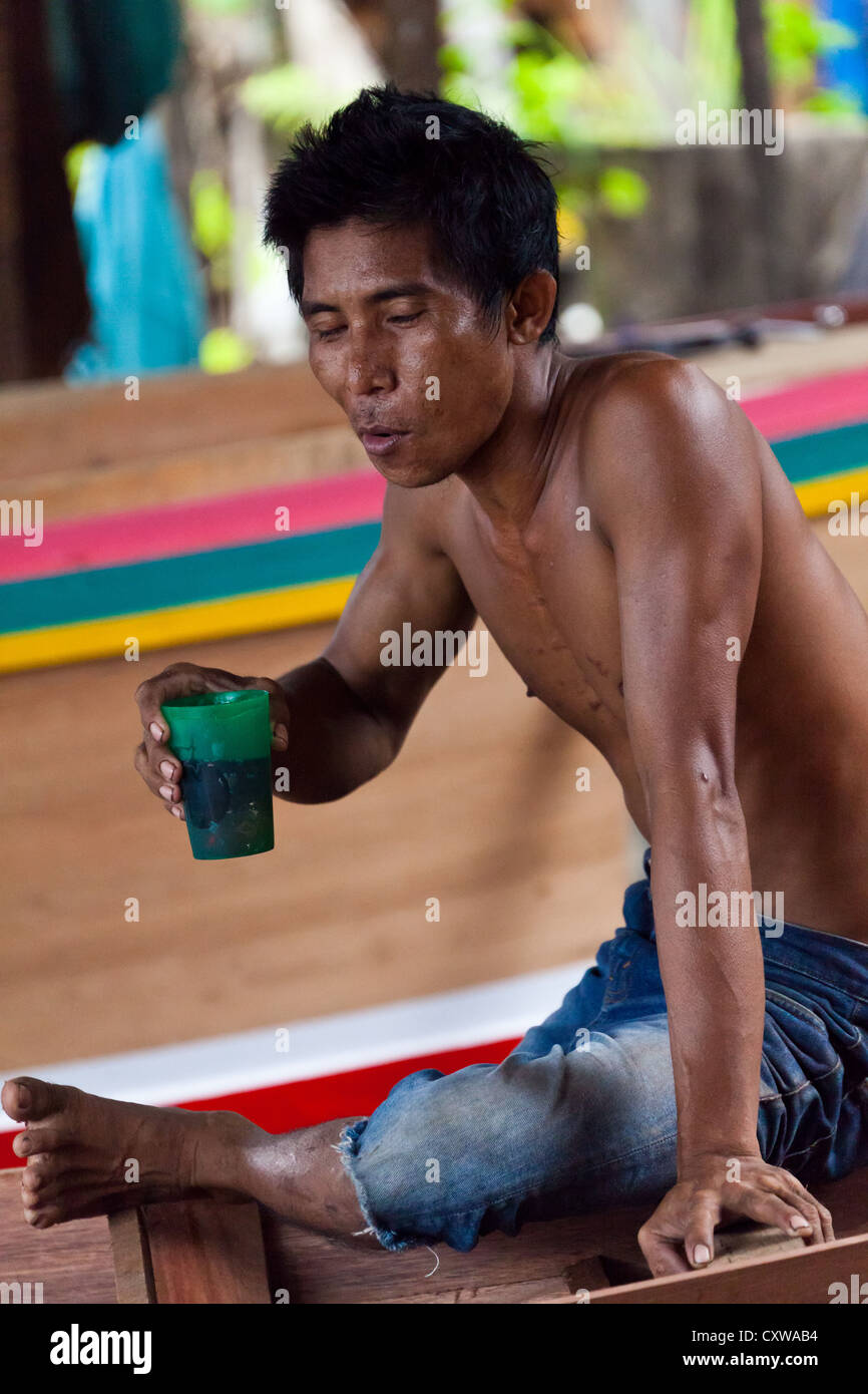 Boat Builder on a traditional Shipyard for River Boats in Banjarmasin, Kalimantan, Indonesia Stock Photo