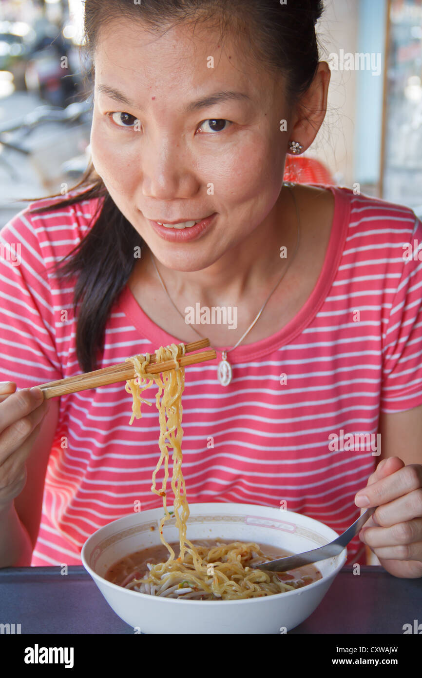 Asian woman eating Stock Photo