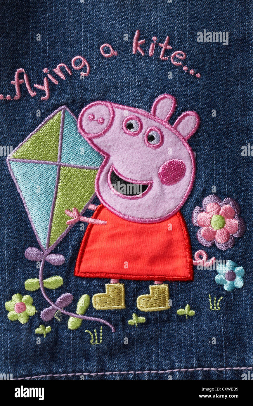 Peppa Pig flying a kite - detail on child's denim jeans Stock Photo - Alamy