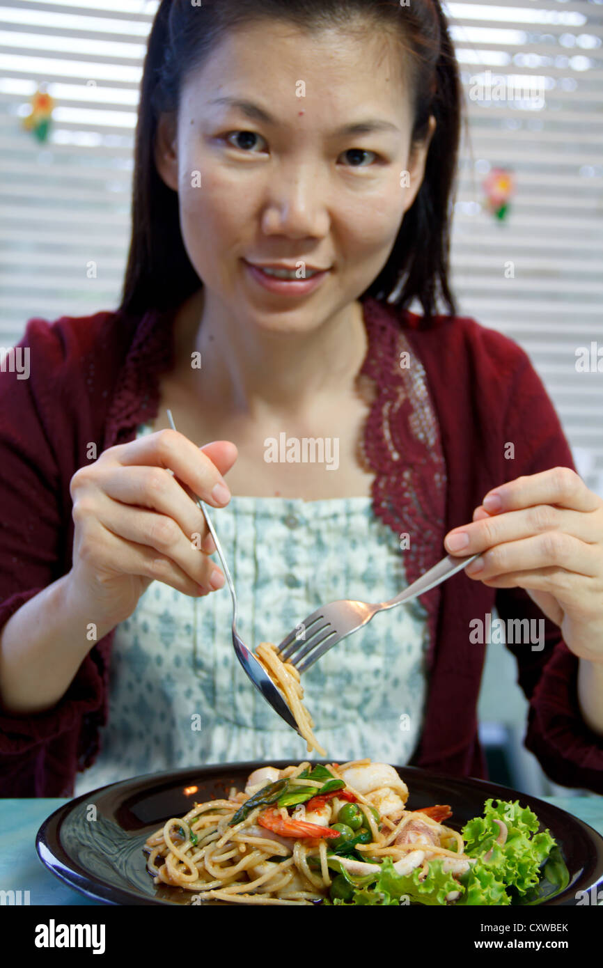 asian eating spaghetti seafood Stock Photo
