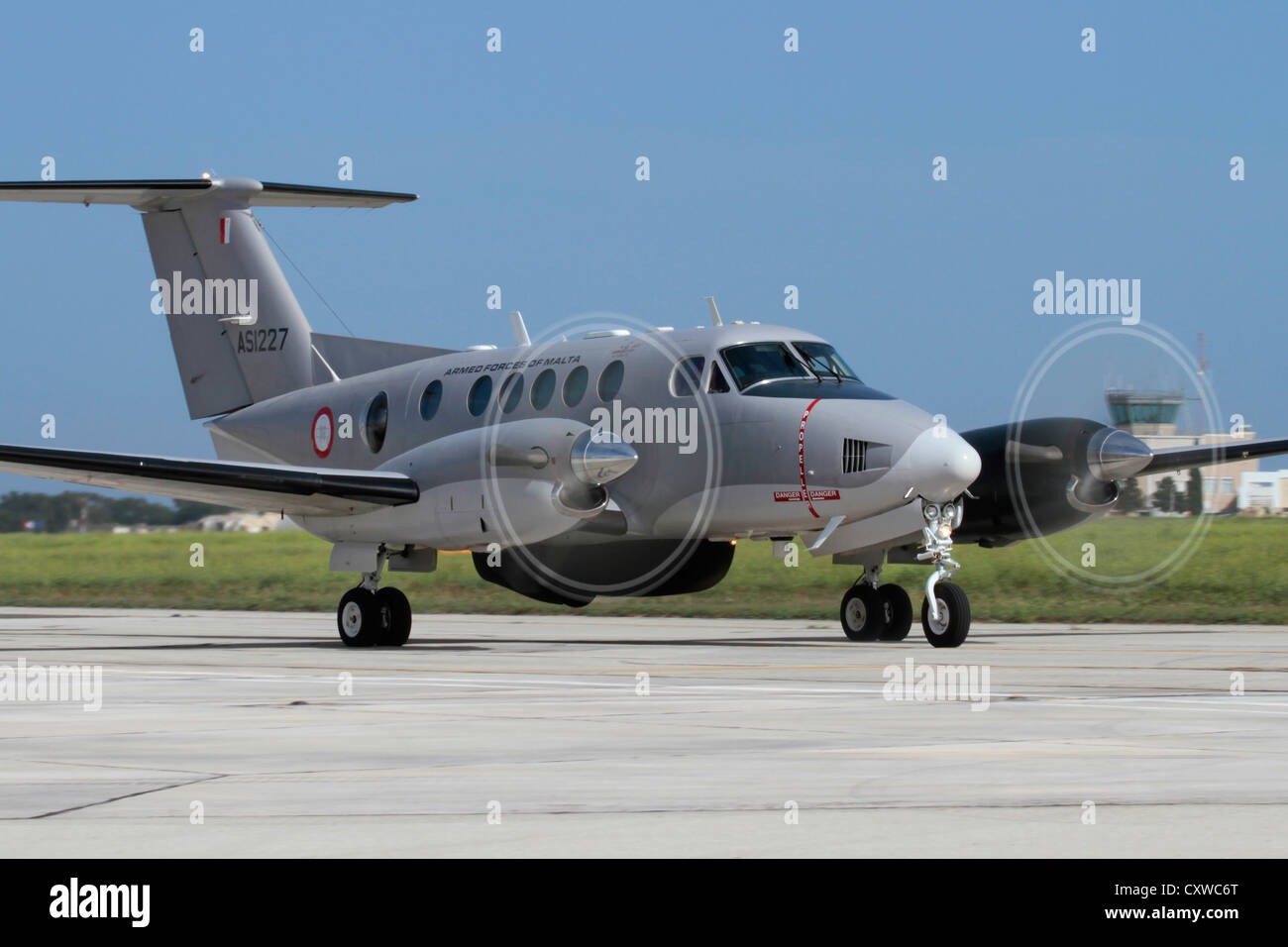 Beechcraft King Air twin-engine search and rescue propeller plane of the Armed Forces of Malta taxiing. Front view emphasising engines and prop blur. Stock Photo