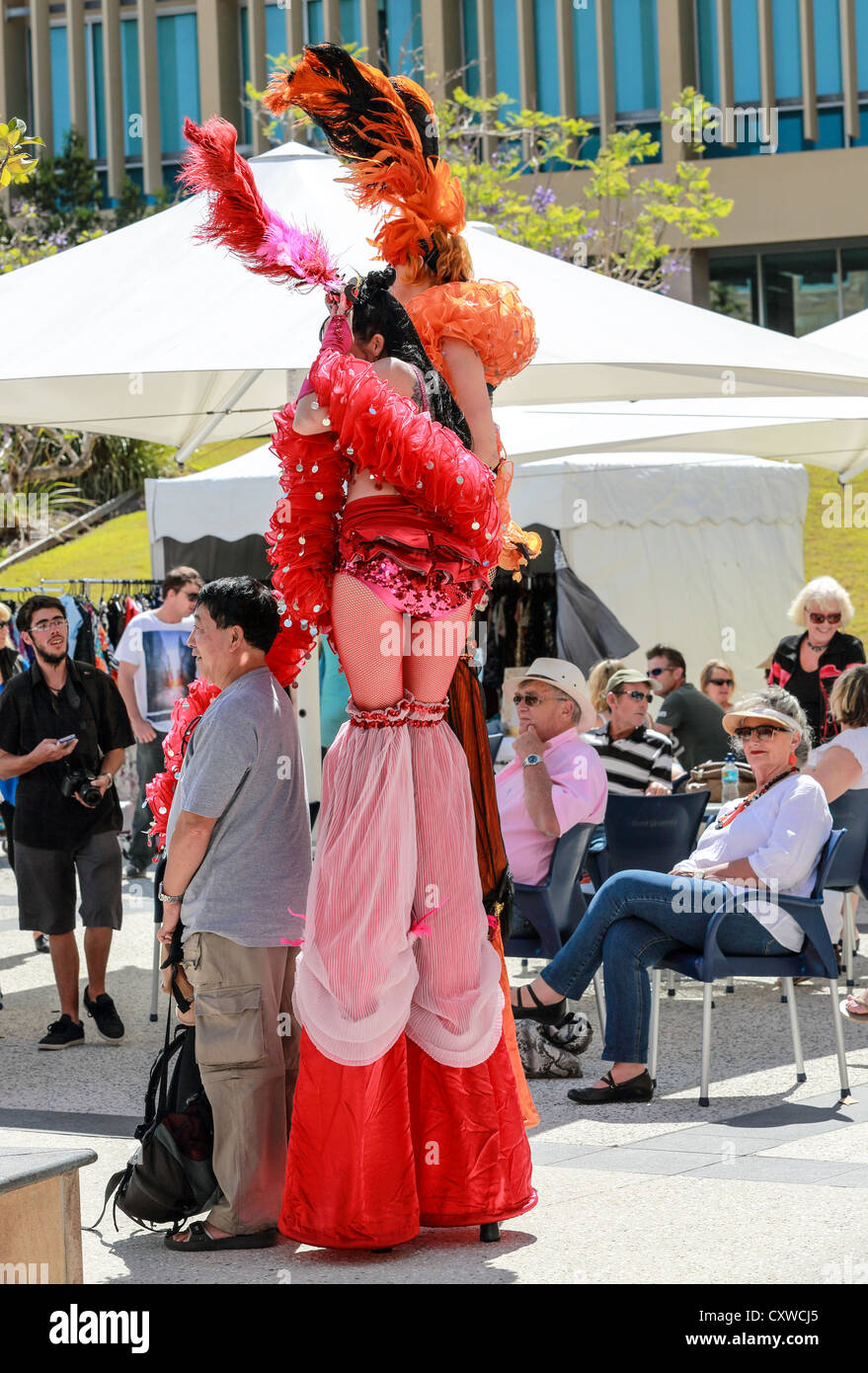 Street performers on stilts and makeup at creative festival Stock Photo