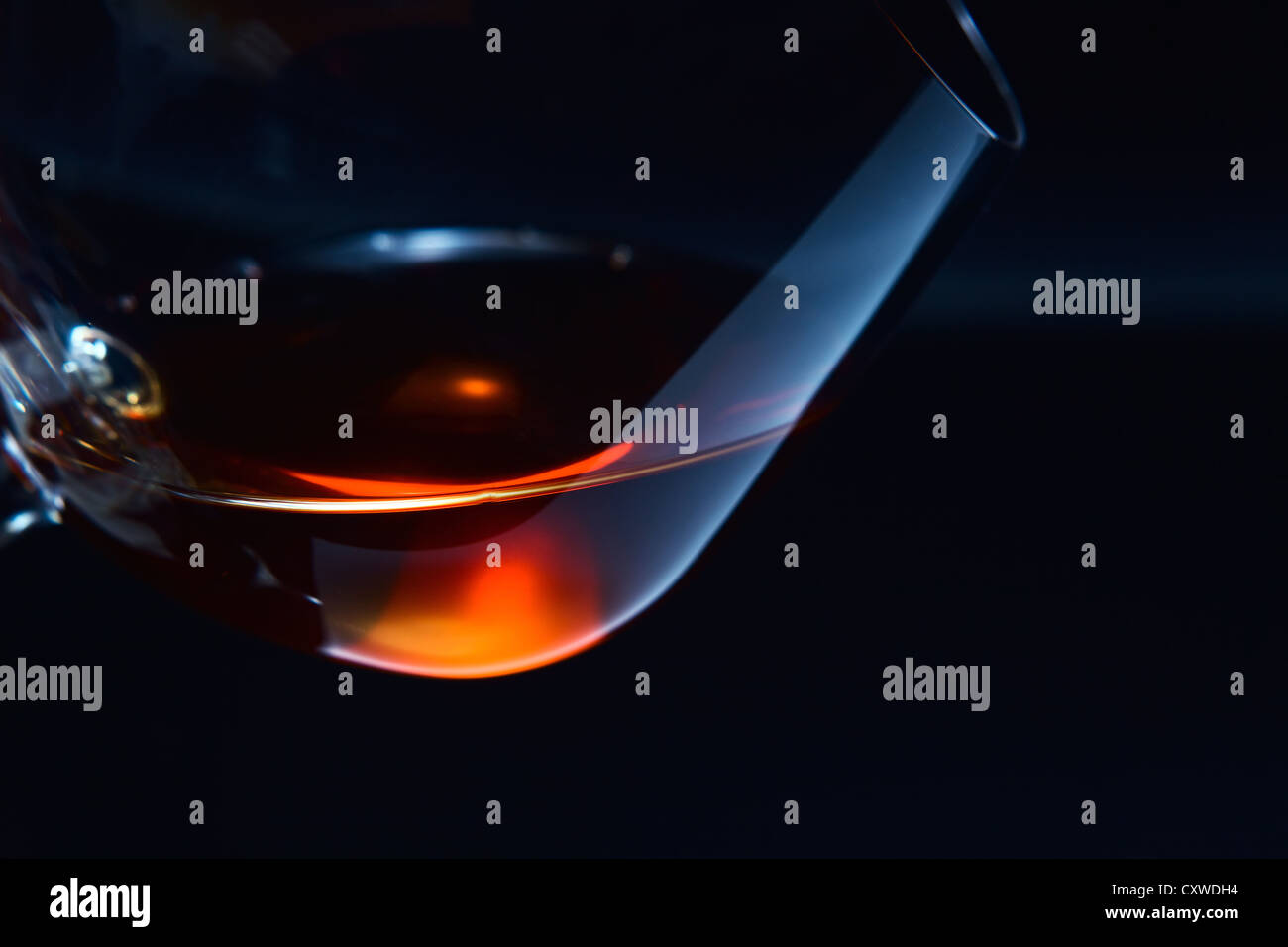 snifter with brandy on a dark background. Stock Photo