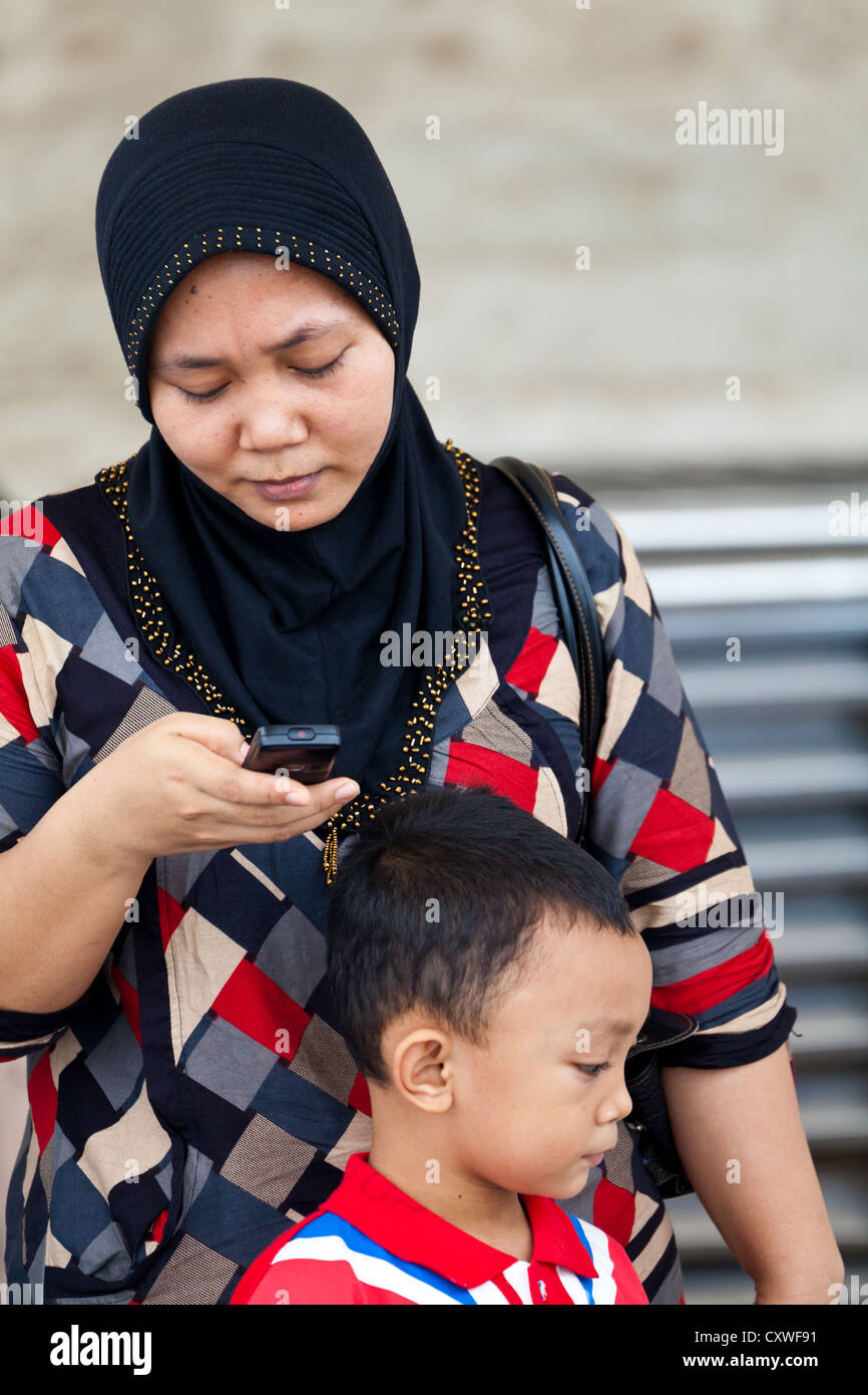 Woman with little Boy at the National Monument in Jakarta, Indonesia Stock Photo