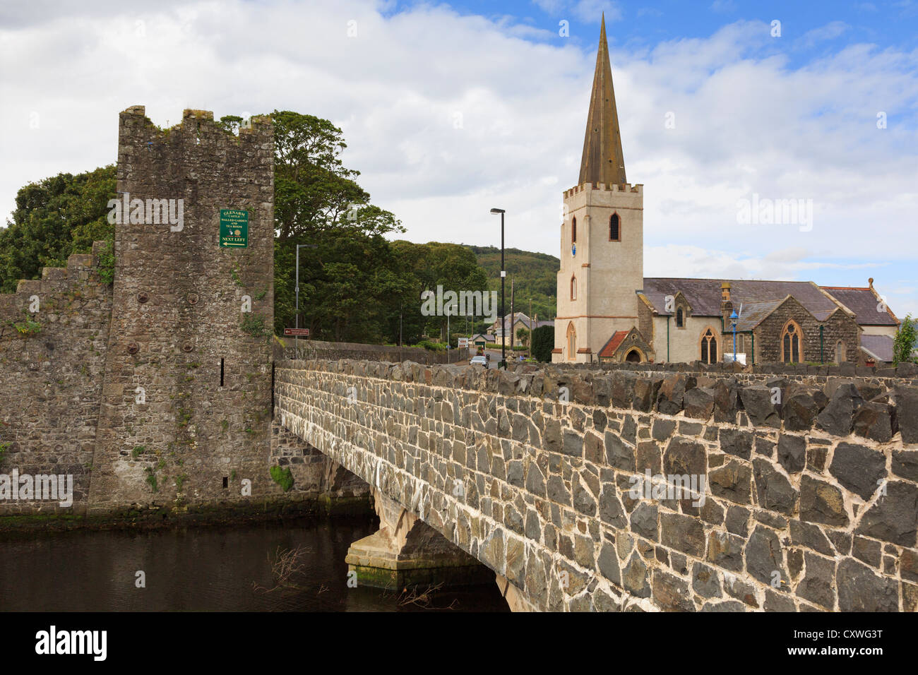 A2 Causeway Coast road bridge over Glenarm River with castle walls and St Patrick's church in Glenarm Co Antrim Northern Ireland Stock Photo