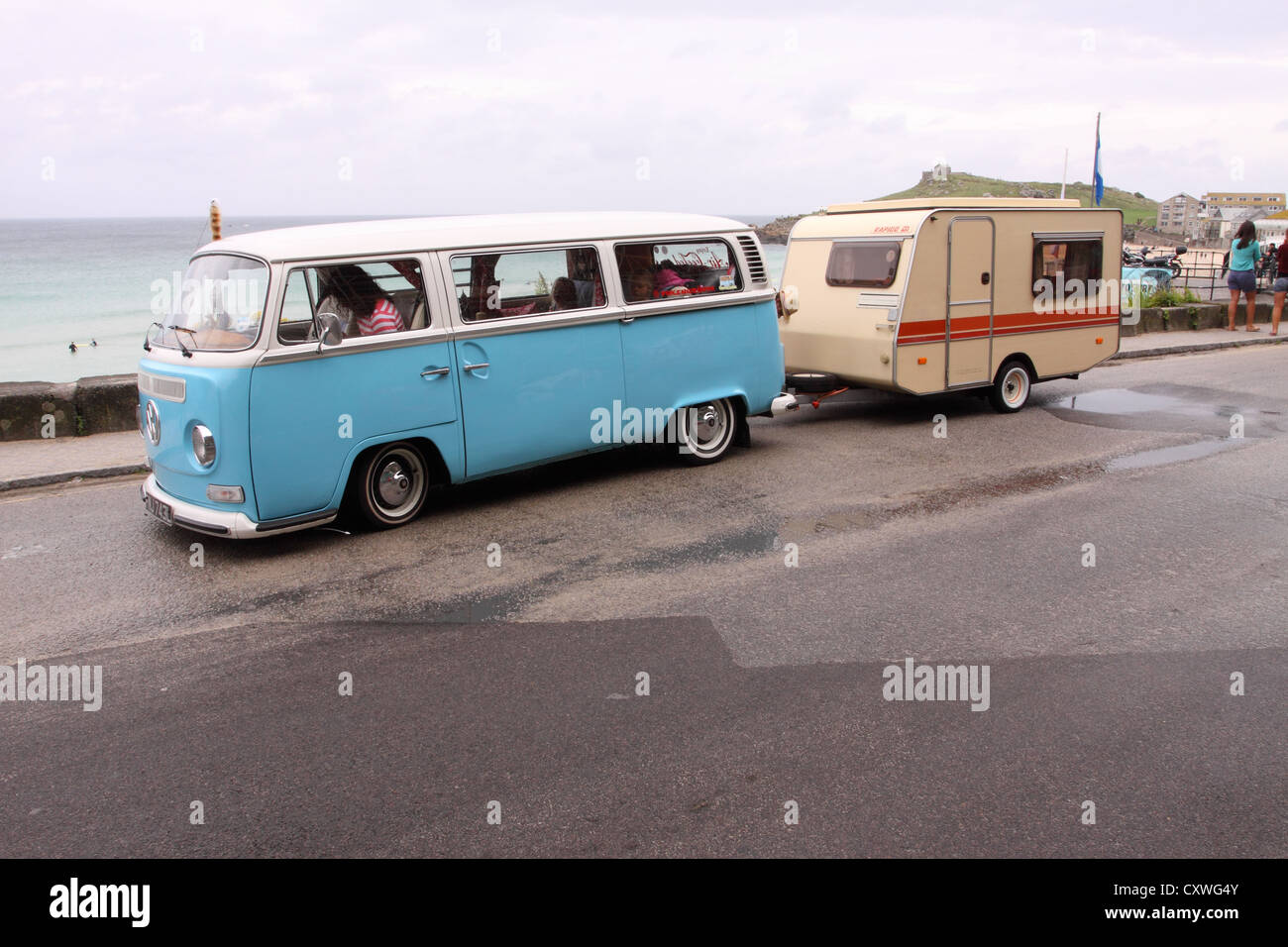 Volkswagen Camper van towing a small Rapido caravan on the sea front at St Ives Cornwall UK Stock Photo
