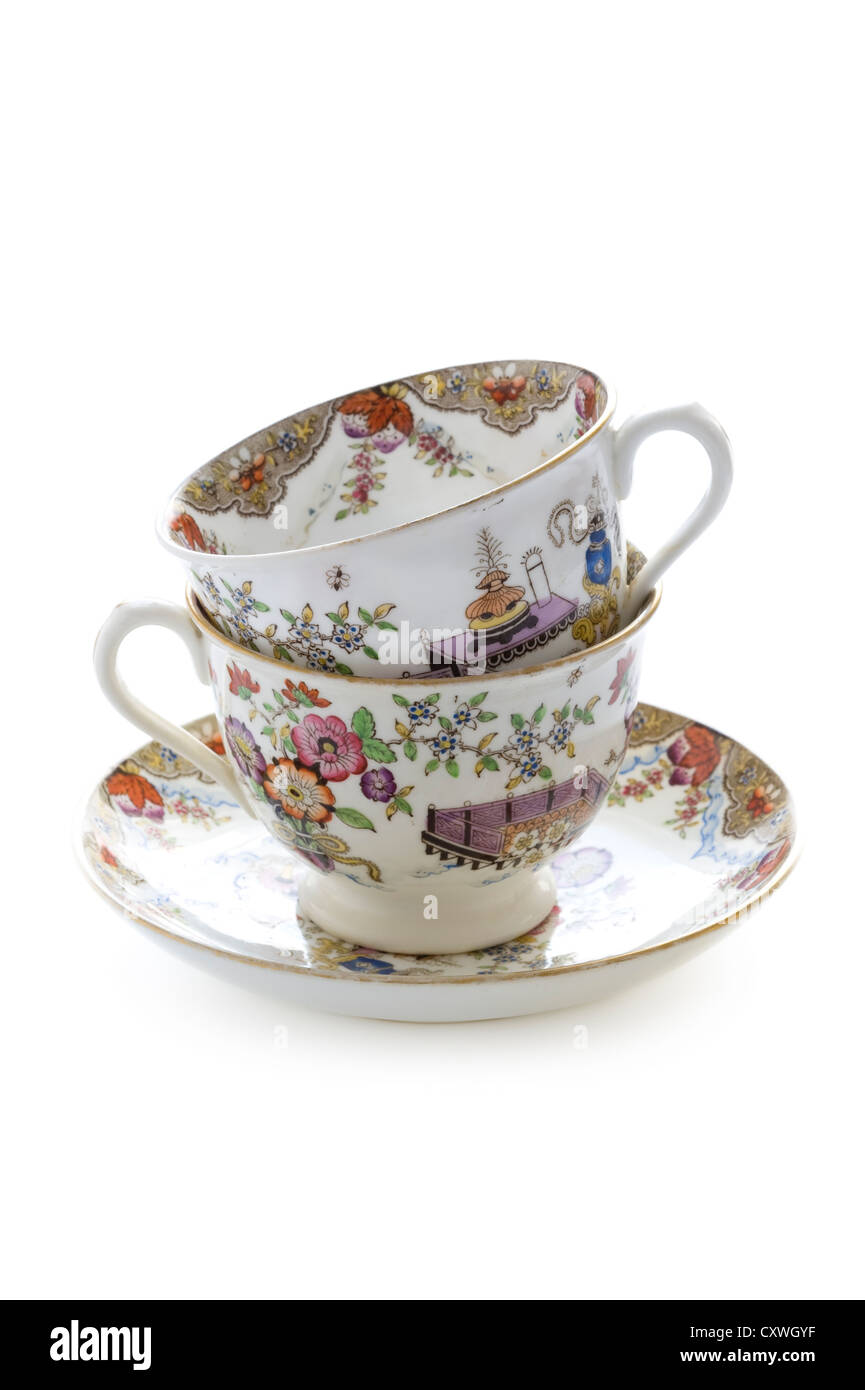 two vintage china tea cups stacked isolated on white Stock Photo Alamy