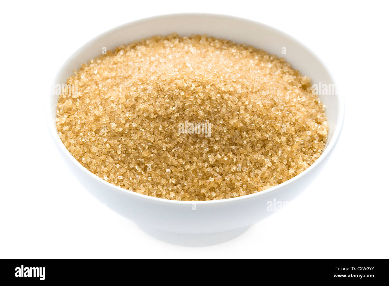 granulated demerara sugar in a bowl isolated on white background Stock Photo