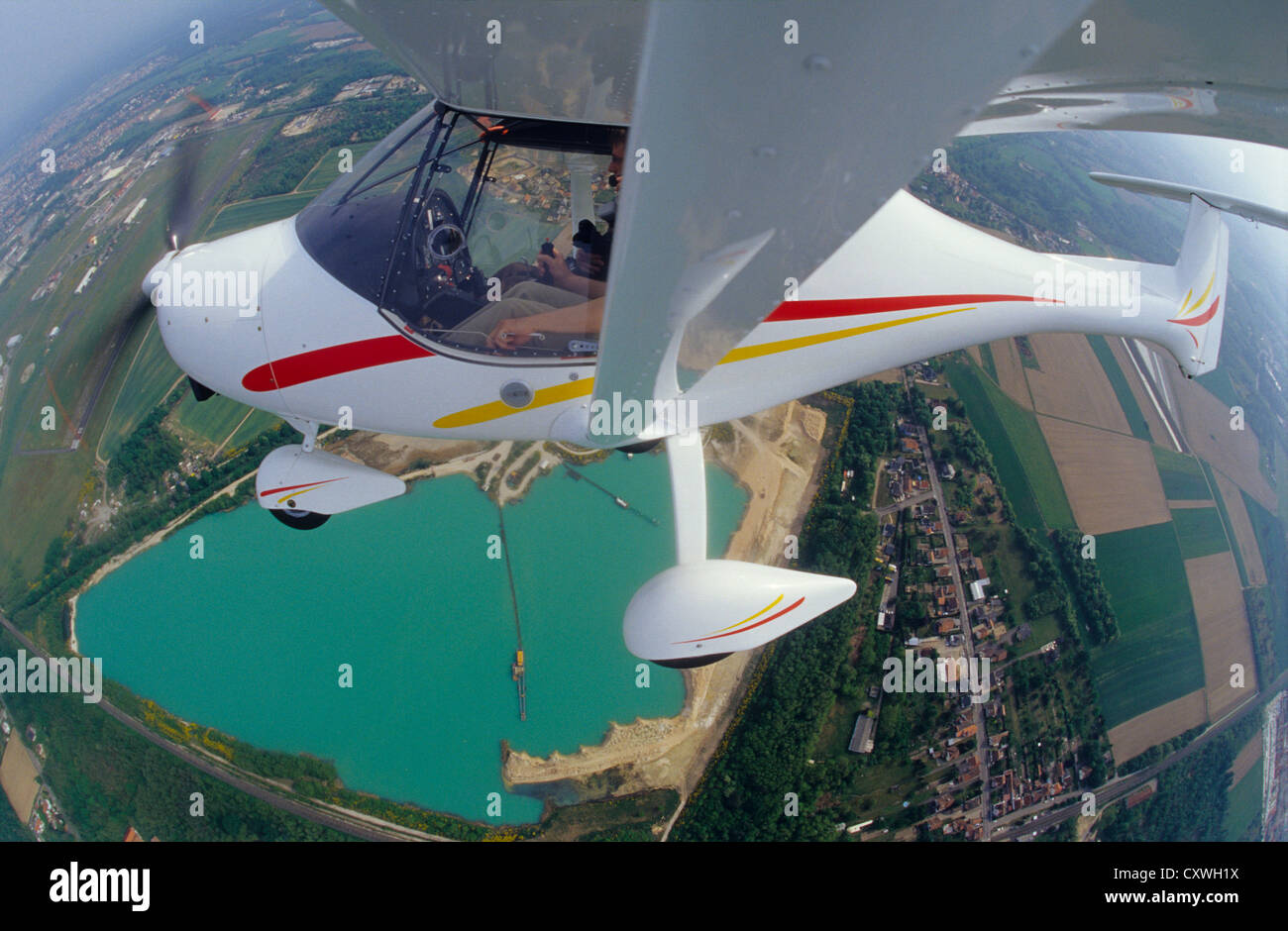 Ultralight plane Allegro flying over lake near Haguenau, Bas-Rhin, Alsace region, France Stock Photo