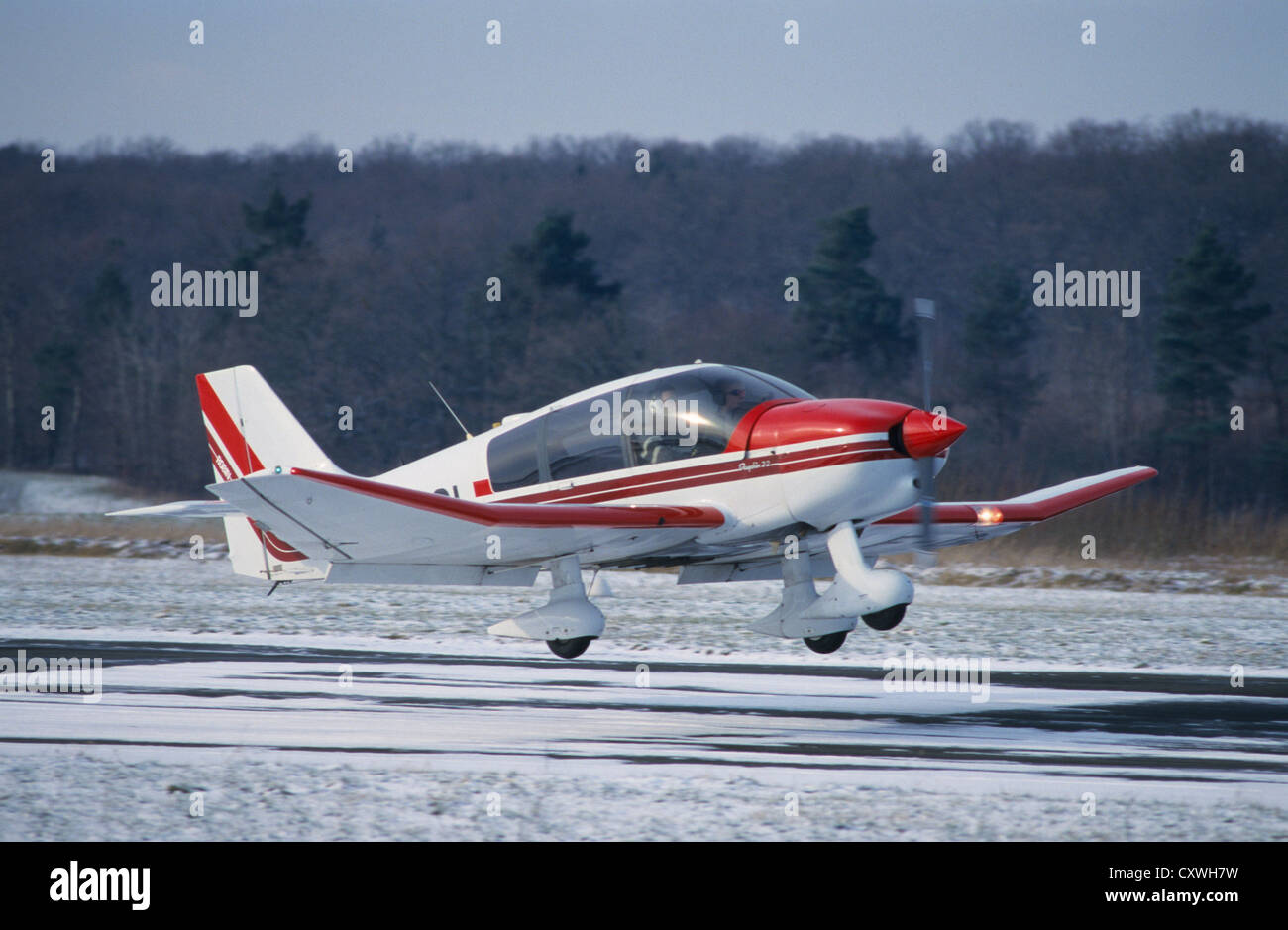 Small french plane Robin DR400180 landing on an iced runway in