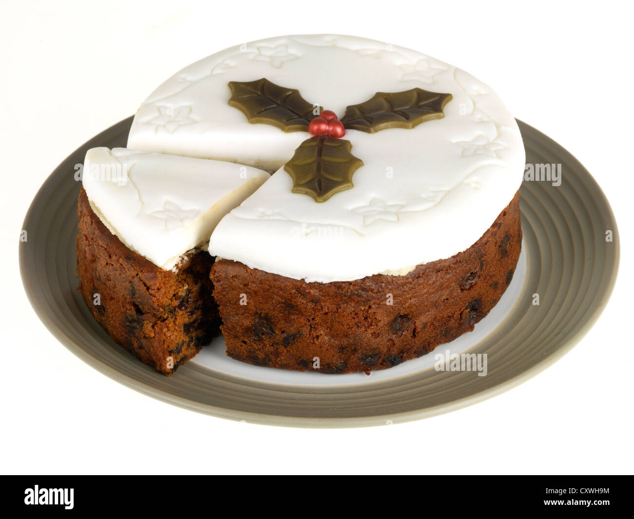 Rich Traditional Festive Christmas Fruit Cake With White Icing, Decorated With Holly Leaves, No People Isolated Against A White Background Stock Photo