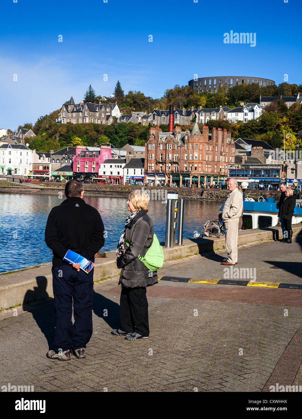 Oban from the harbour with McCaig's Tower on the hill, Oban, Argyll, Scotland. Stock Photo