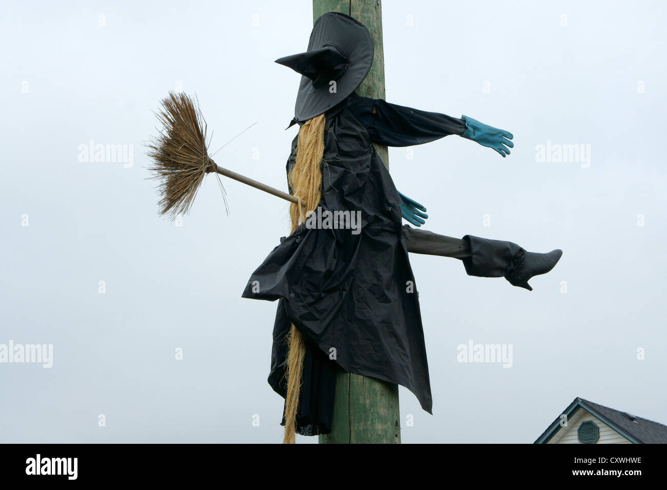 Humorous Halloween sculpture of an unlucky flying witch hitting a telephone pole Stock Photo