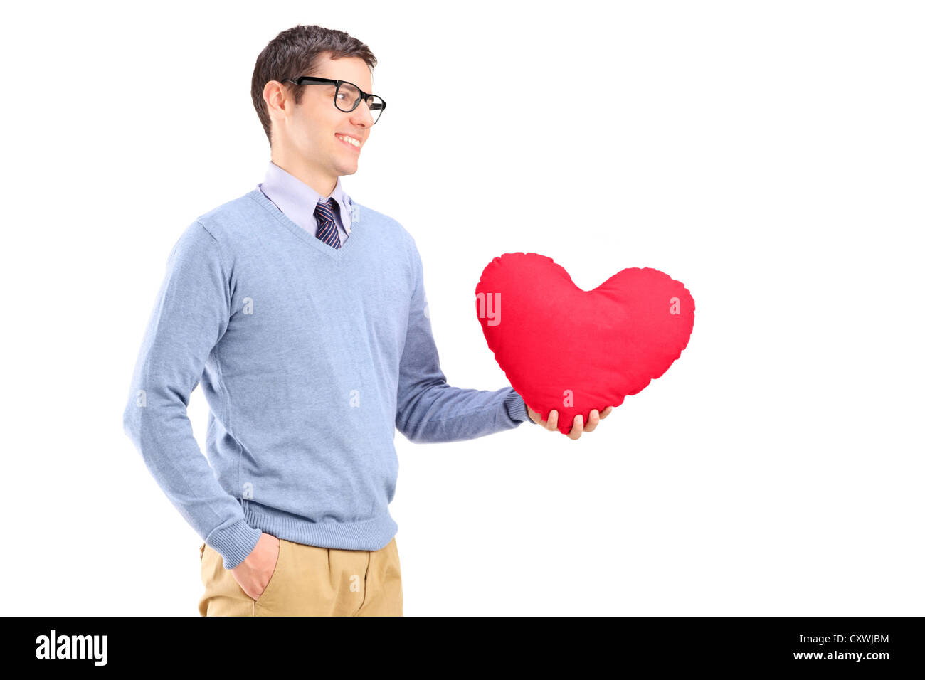A young man holding a red heart isolated on white background Stock ...
