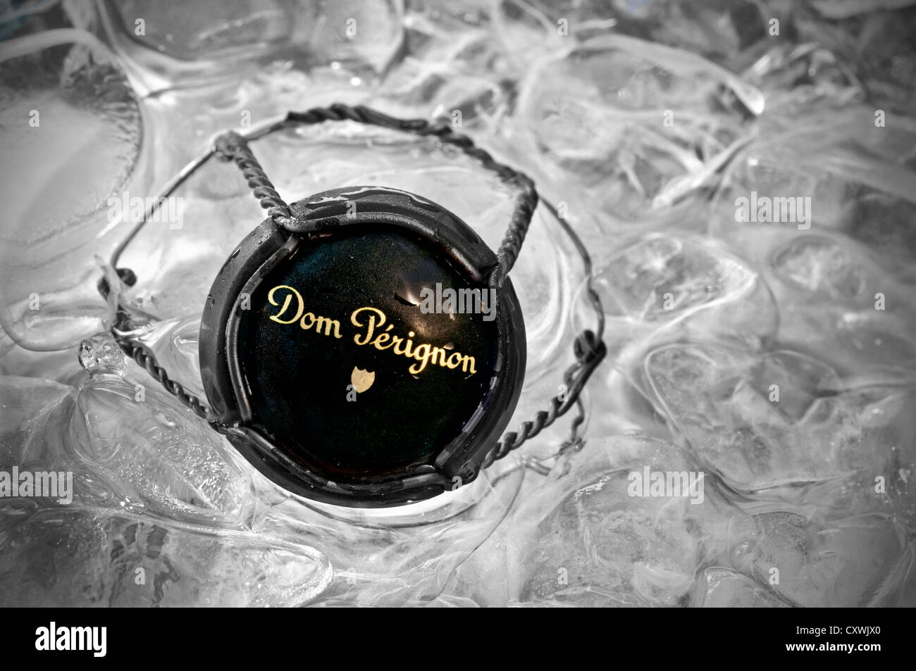 'Dom Perignon' vintage champagne close-up on wire retaining frame and metal top cap in ice bucket (B&W/Colour) Stock Photo