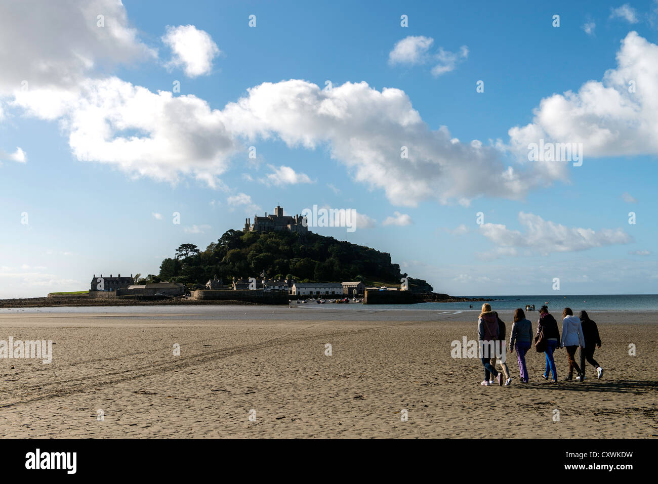 People walking to St Michaels Mount during low tide, Mount's Bay coast of Cornwall England UK Stock Photo