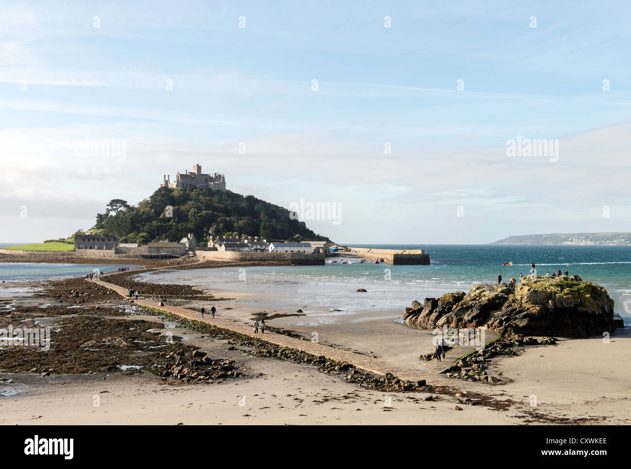 People walking to St Michaels Mount during low tide Mount's Bay coast of Cornwall England UK Stock Photo