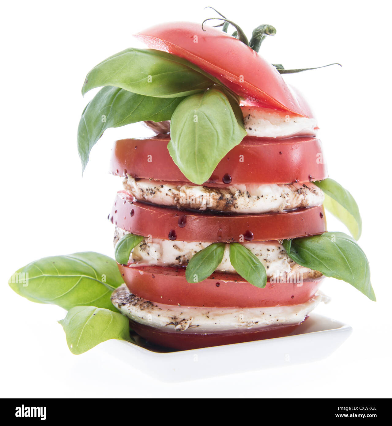 Layered slices of Tomato and Mozzarella isolated on white background