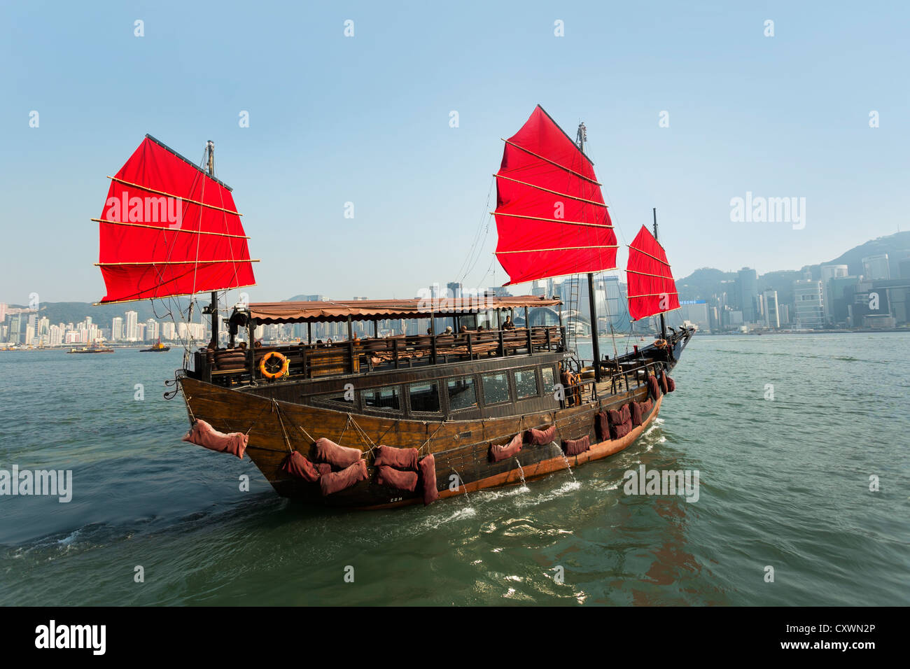 Junk Boat sailing on Victoria Harbour, Hong Kong, China. Stock Photo