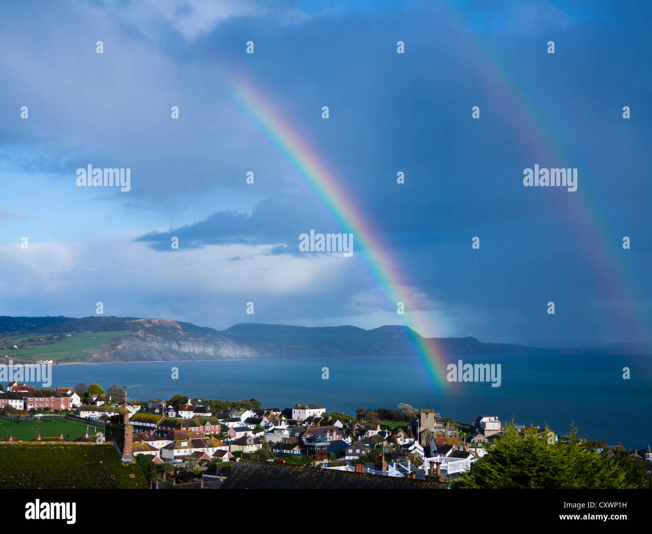 Double rainbow over Lyme Bay, from Lyme Regis looking towards Golden Cap Stock Photo