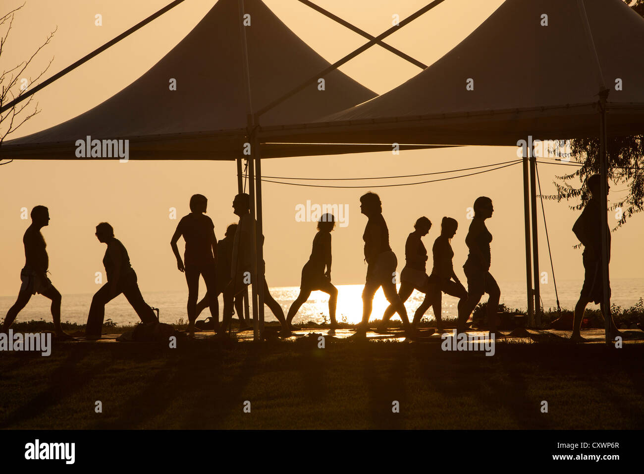 Holiday makers at a stretch and relax class on Lemnos, Greece at sunset. Stock Photo