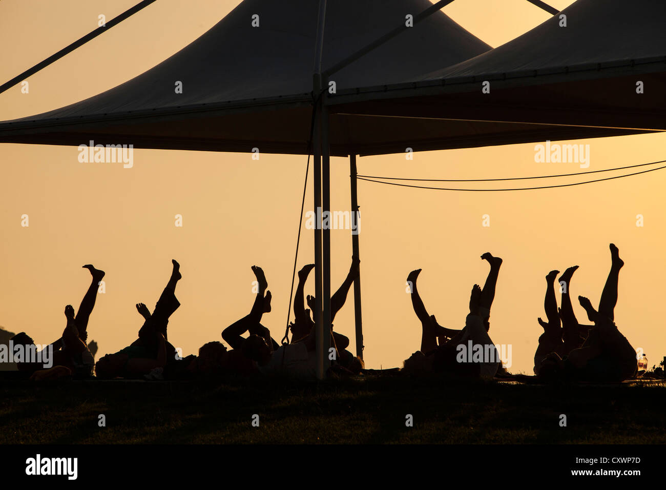 Holiday makers at a stretch and relax class on Lemnos, Greece at sunset. Stock Photo