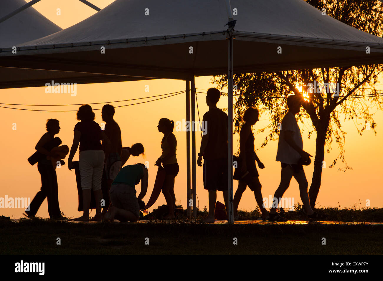 Holiday makers at a stretch and relax class on Lemnos, Greece at sunset. Stock Photo