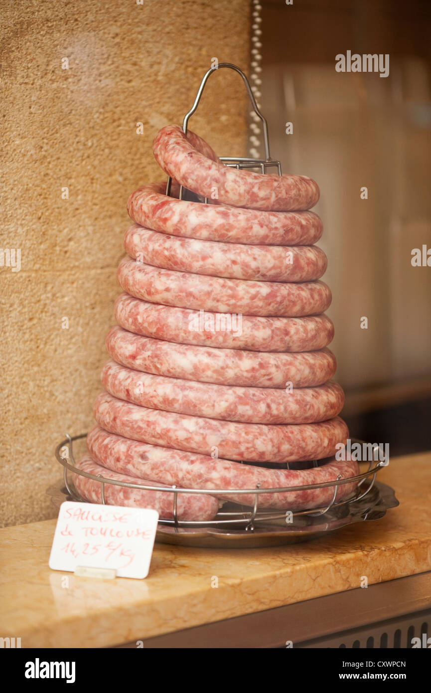 Coiled sausage in butchers shop Stock Photo