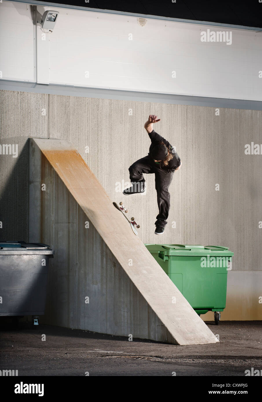 Man skating on urban ramp Stock Photo