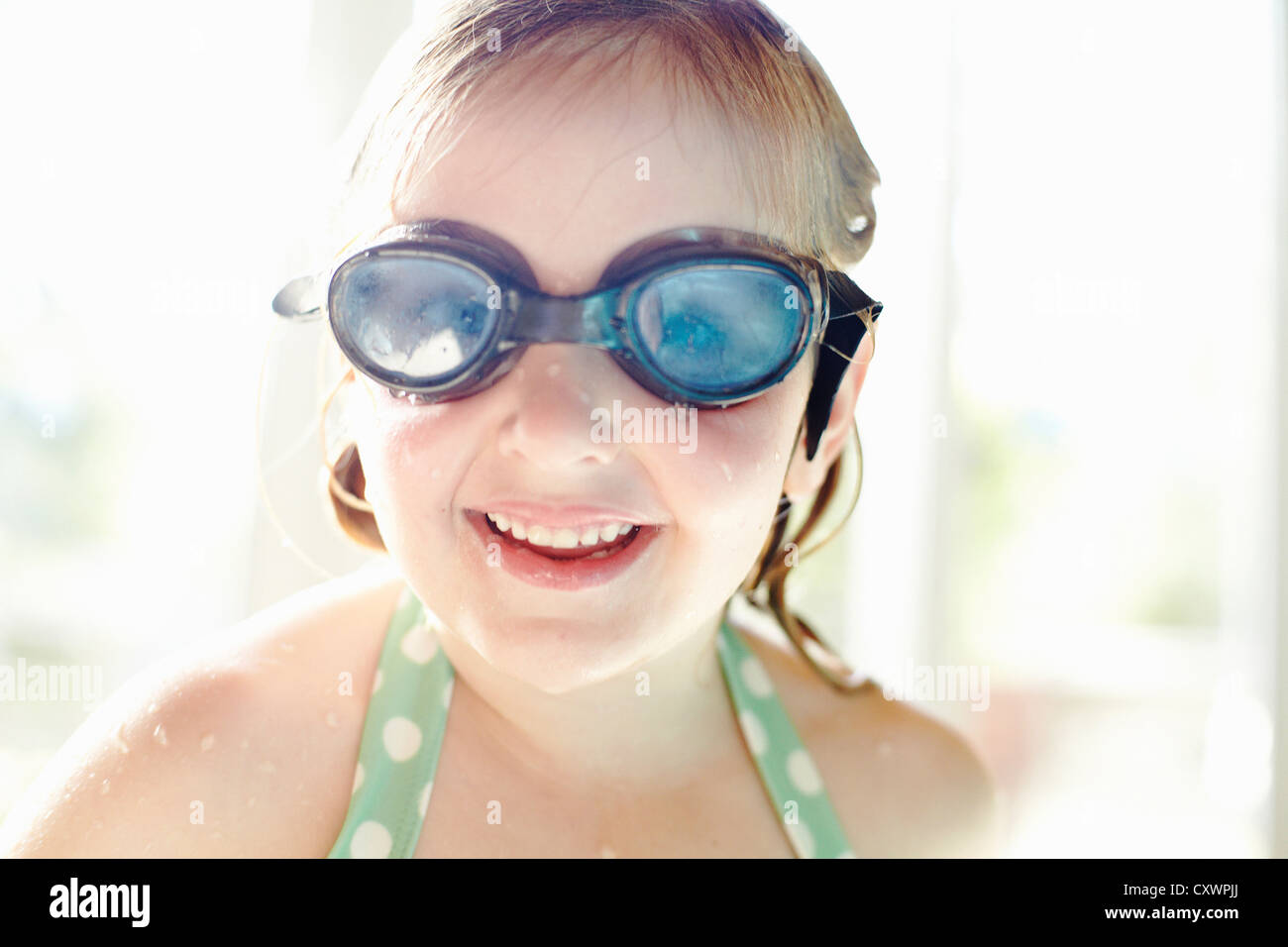 Smiling girl wearing goggles Stock Photo Alamy