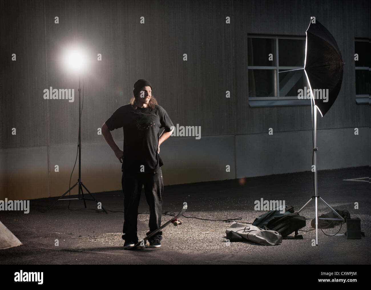 Skater standing under photo lights Stock Photo