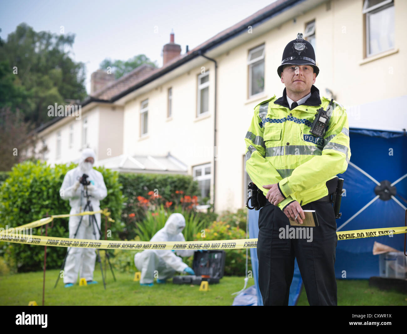 Policeman guarding forensic crime scene Stock Photo