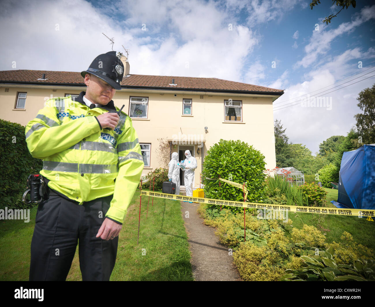 Policeman guarding forensic crime scene Stock Photo