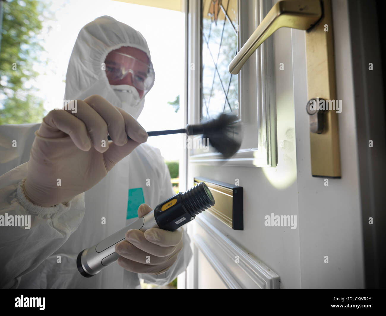 Forensic scientist dusting door Stock Photo