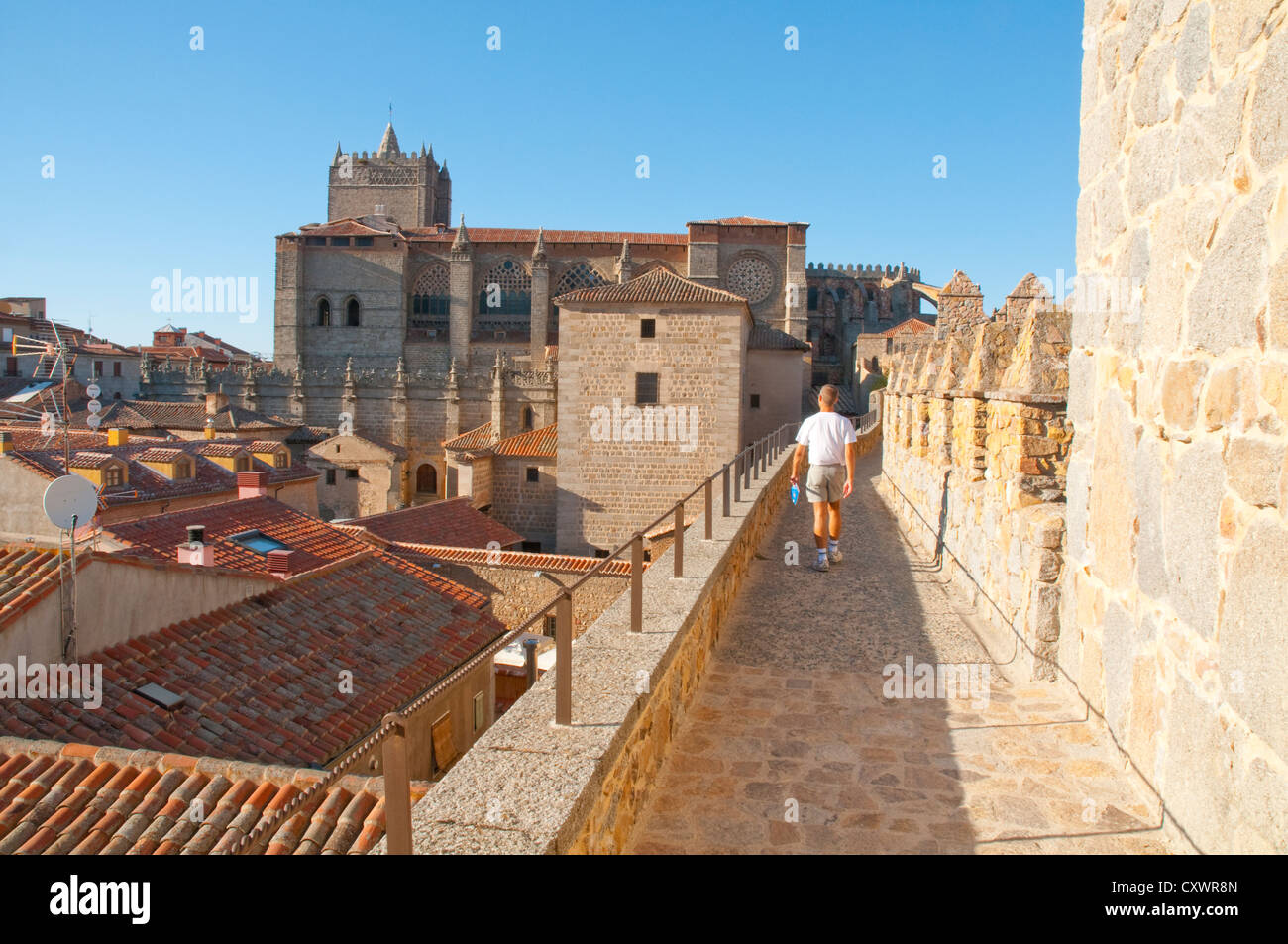 Man walking along the city wall. Avila, Castilla Leon, Spain. Stock Photo