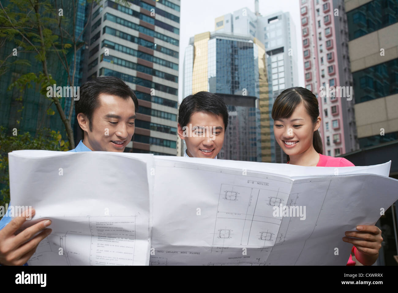 Business people reading blueprints Stock Photo