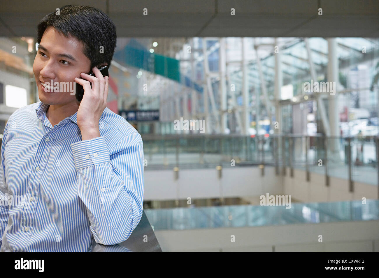 Businessman on cell phone on city street Stock Photo