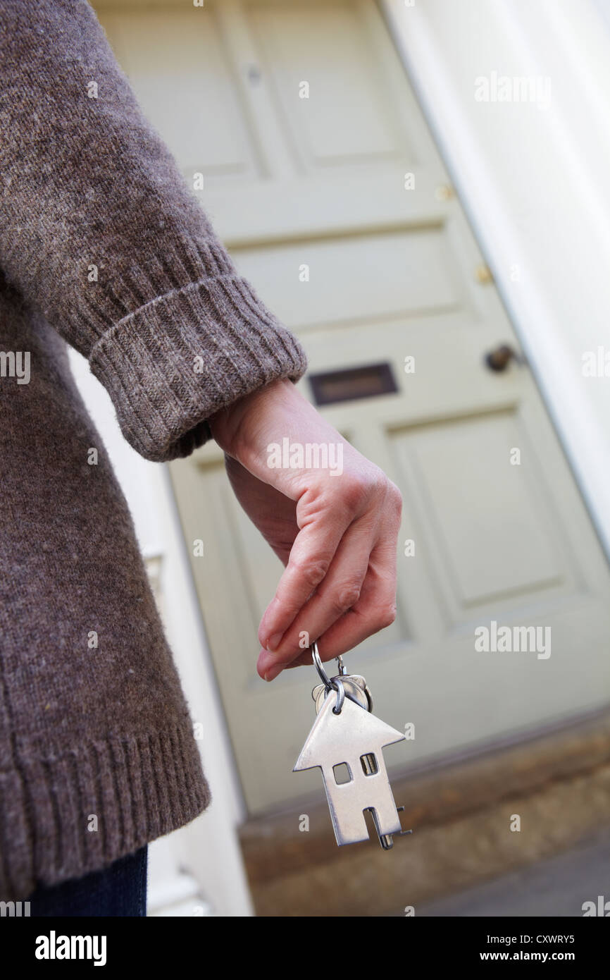 Woman Holding Keys To New Home Outside Front Door Stock Photo - Alamy