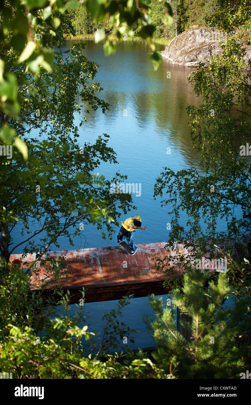 Boy standing on dock in lake Stock Photo